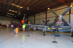 Rare sight of three different types of North American P-51's in various stages of maintenance (Voodoo in the back left))